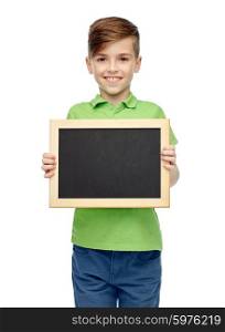 childhood, education, school, advertisement and people concept - happy smiling boy in green polo t-shirt holding black blank chalk board