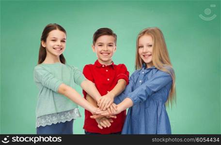 childhood, education, school, friendship and people concept - happy smiling children with hands on top over green chalk board background