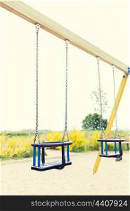 childhood, equipment and object concept - baby swing on playground outdoors