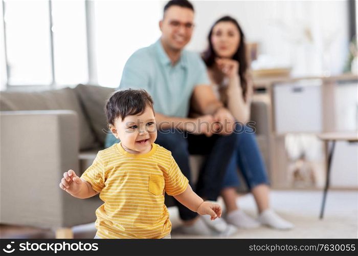 childhood, family and people concept - happy baby boy and parents at home. happy baby boy and parents at home