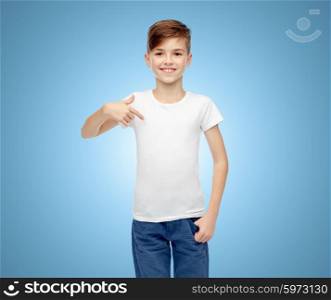 childhood, fashion, advertisement and people concept - happy boy in white t-shirt and jeans pointing finger to himself over blue background