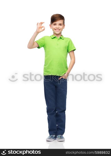 childhood, fashion, advertisement and people concept - happy boy in white t-shirt and jeans showing ok hand sign