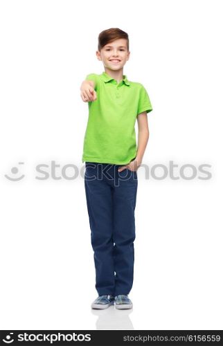 childhood, fashion, advertisement and people concept - happy boy in white t-shirt and jeans pointing finger to you