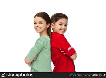childhood, fashion and people concept - happy smiling boy and girl standing back to back