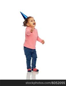 childhood, fashion, birthday, holidays and people concept - happy smiling african american little baby girl with birthday party hat looking up at something