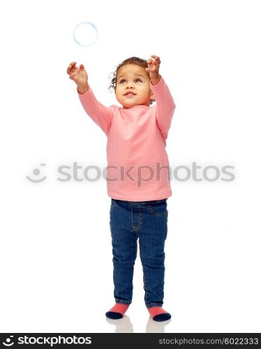 childhood, fashion, clothing and people concept - beautiful little african american baby girl playing with soap bubble