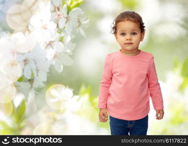 childhood, fashion, clothing and people concept - beautiful little african american baby girl portrait over cherry blossoms background