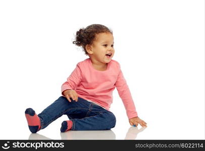 childhood, fashion, clothing and people concept - smiling beautiful african american little baby girl sitting on floor