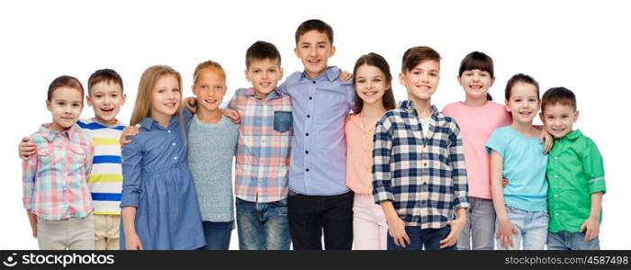 childhood, fashion, friendship and people concept - group of happy smiling children hugging over white background