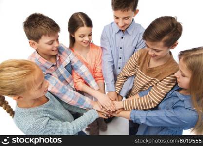 childhood, fashion, friendship and people concept - happy children with hands on top