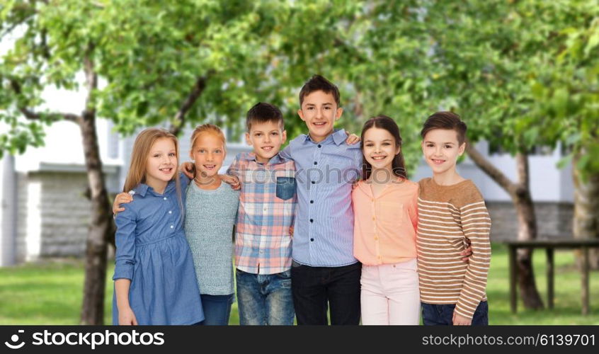 childhood, fashion, friendship and people concept - happy smiling children hugging over private house backyard background