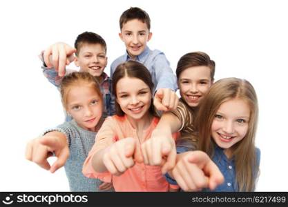 childhood, fashion, friendship and people concept - happy smiling children pointing finger to you