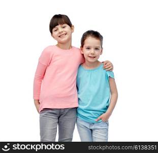childhood, fashion, friendship and people concept - happy smiling little girls hugging