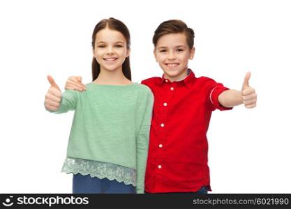 childhood, fashion, gesture and people concept - happy smiling boy and girl hugging and showing thumbs up