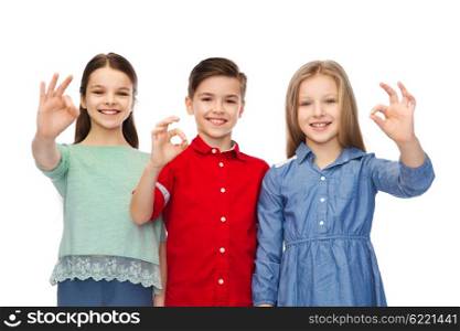 childhood, fashion, gesture and people concept - happy smiling boy and girl hugging and showing ok hand sign