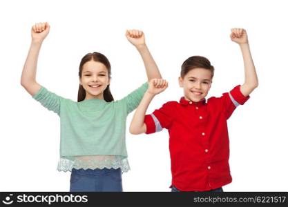 childhood, fashion, gesture and people concept - happy smiling boy and girl raising fists and celebrating victory