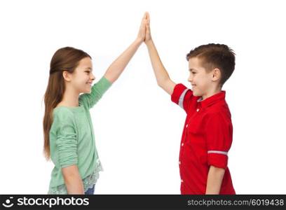 childhood, fashion, gesture and people concept - happy smiling boy and girl making high five