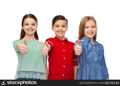 childhood, fashion, gesture and people concept - happy smiling boy and girls showing thumbs up