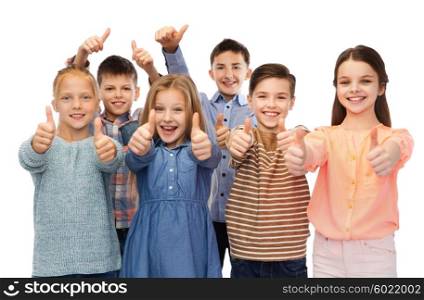 childhood, fashion, gesture and people concept - happy smiling children showing thumbs up