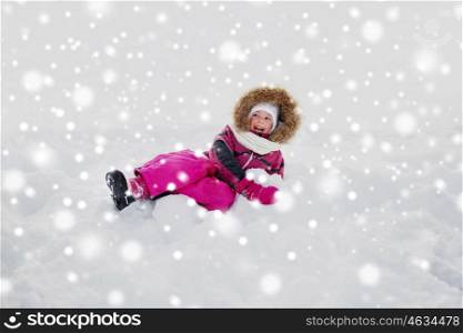 childhood, fashion, season and people concept - face of happy little kid or girl in winter clothes on snow