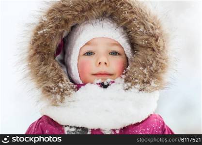 childhood, fashion, season and people concept - face of happy little kid or girl in winter clothes