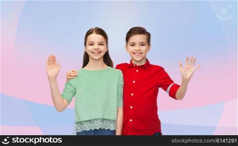 childhood, friendship, gesture and people concept - happy smiling boy and girl hugging and waving hand over pink violet background