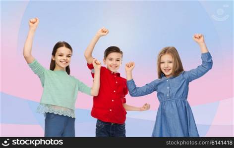 childhood, friendship, success, gesture and people concept - happy smiling boy and girls raising fists and celebrating victory over pink violet background