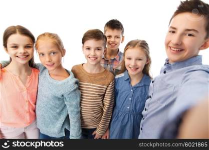 childhood, friendship, technology and people concept - happy children talking selfie
