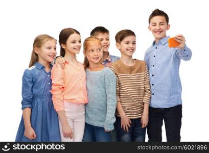 childhood, friendship, technology and people concept - happy children talking selfie by smartphone