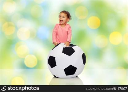 childhood, game, sport, football and people concept - happy african american little baby girl playing with ball
