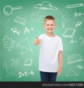 childhood, gesture, education, advertisement and people concept - smiling boy in white t-shirt showing thumbs up over green board with doodles background