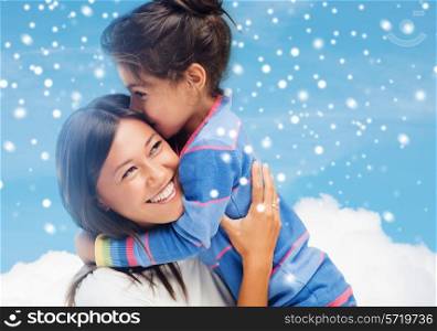 childhood, happiness, family and people concept - smiling little girl and mother hugging over blue snowy sky with cloud background