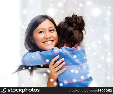 childhood, happiness, family and people concept - smiling little girl and mother hugging indoors