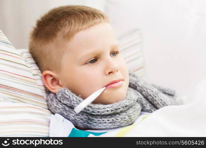 childhood, healthcare and medicine concept - ill boy with flu at home