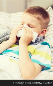childhood, healthcare and medicine concept - ill boy with flu at home