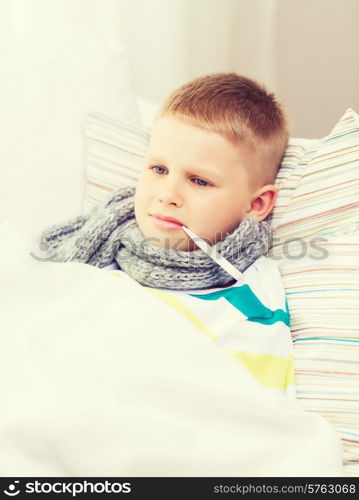 childhood, healthcare and medicine concept - ill boy with flu at home