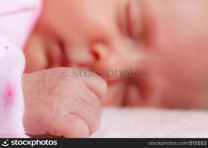 Childhood innocence concept. Little adorable newborn baby sleeping on bed with many blankets.. Little newborn baby sleeping in blanket