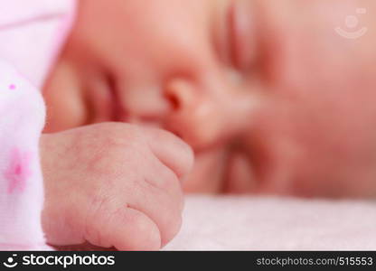 Childhood innocence concept. Little adorable newborn baby sleeping on bed with many blankets.. Little newborn baby sleeping in blanket