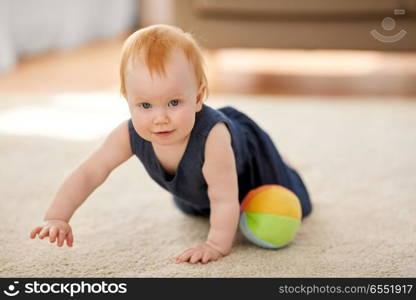 childhood, kids and people concept - lovely redhead baby girl with toy ball at home. lovely redhead baby girl with toy ball at home. lovely redhead baby girl with toy ball at home