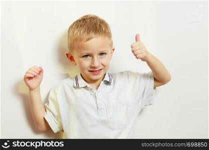 Childhood, kids imagination and gestures concept. Little young boy playing having fun, showing thumb up gesture. Little boy playing showing thumb up gesture