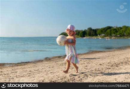 childhood, leisure and people concept - happy little baby girl with ball running along summer beach. happy baby girl with ball running on summer beach