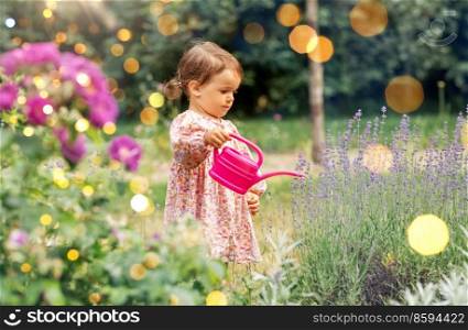 childhood, leisure and people concept - happy little baby girl with watering can in summer garden. happy baby girl with watering can in summer garden