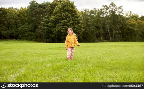 childhood, leisure and people concept - happy little girl in summer park. happy girl in summer park