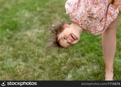 childhood, leisure and people concept - happy smiling little baby girl having fun outdoors in summer. happy smiling little baby girl having fun outdoors