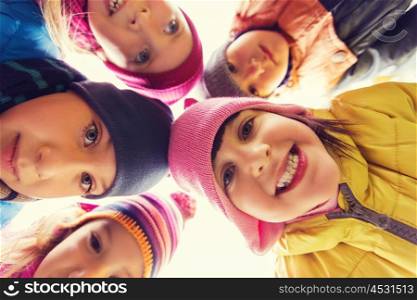 childhood, leisure, friendship and people concept - group of happy children faces in circle