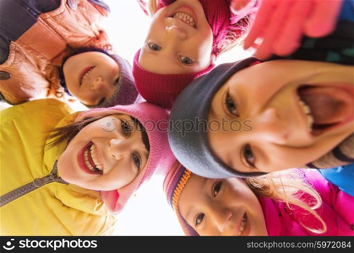 childhood, leisure, friendship and people concept - group of happy children faces in circle