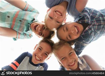 childhood, leisure, friendship and people concept - group of smiling happy children faces in circle