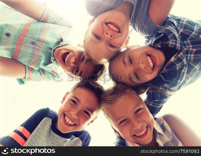 childhood, leisure, friendship and people concept - group of smiling happy children faces in circle. group of happy children faces in circle