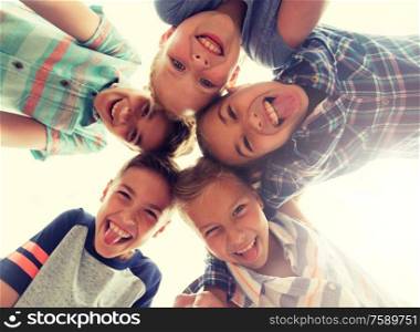 childhood, leisure, friendship and people concept - group of smiling happy children showing tongue in circle. group of happy children showing tongue in circle