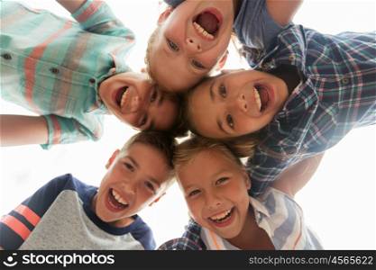 childhood, leisure, friendship and people concept - group of smiling happy laughing children faces in circle